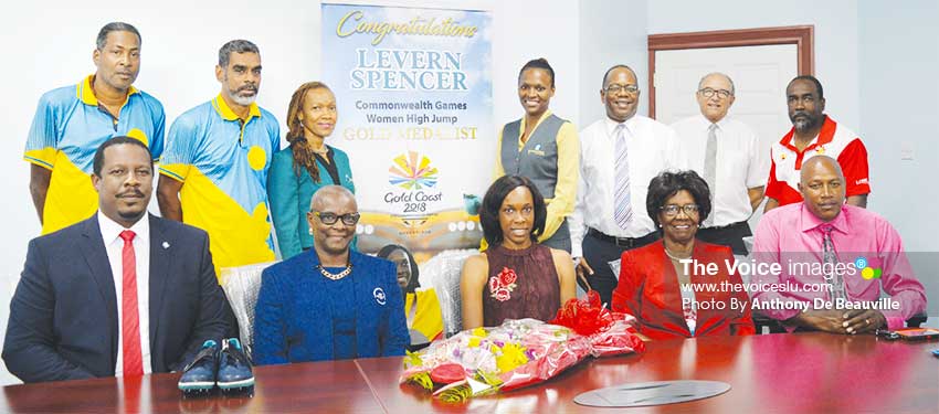 Image: A photo moment with Commonwealth Games gold medal winner Levern Spencer, a dream come true (Back row standing l-r) Ryan O’ Brian, Trevor Hunte, Monica Dudley Cherry Anne Plumber, Robert Fevrier, Richard Peterkin, Alfred Emmanuel (sitting L-R) Johnathan Johannes, Fortuna Belrose, Dame PearletteLouisy, and Gregory Dickson. (PHOTO: Anthony De Beauville)