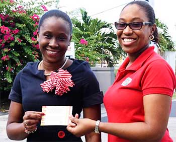 Image: (L-R) DarnicaJn Charles receiving her Jazz tickets from RUBIS West Indies Limited’s, ChriseldaNorbal, Assistant Account Executive. (PHOTO: RUBIS)