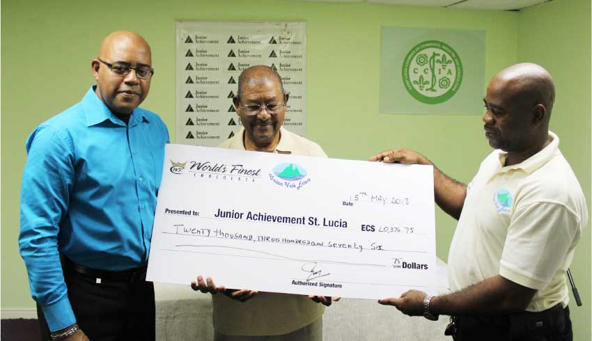 Image of Mr Husbands and Mr George make presentation to Mr Hosam.