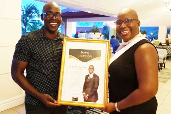 Image of a Beaming St. Rose Jacobie receives his Citation from Minister Gale Rigobert