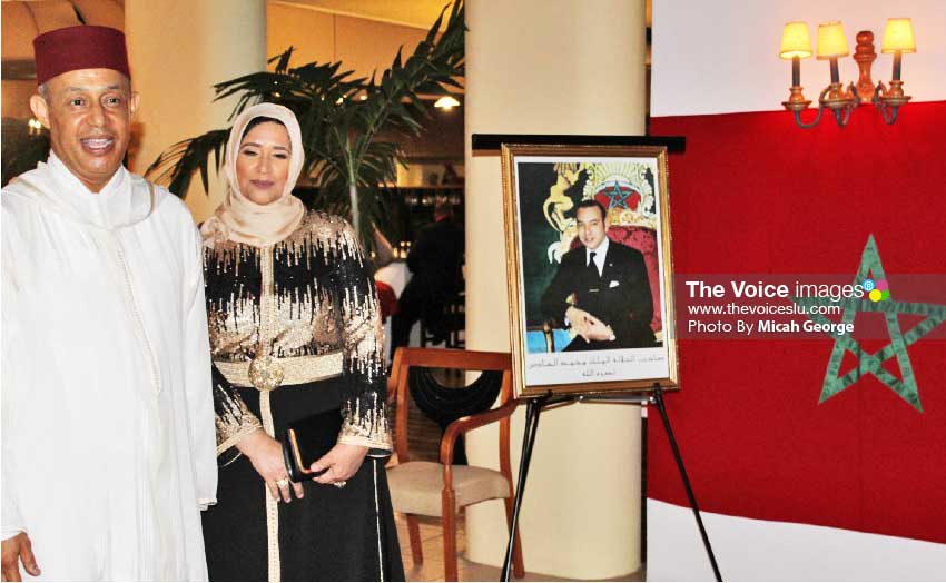 Image of Ambassador Abderrahim and wife next to a portrait of King Mohammed waiting to greet their guests at Monday night’s reception.