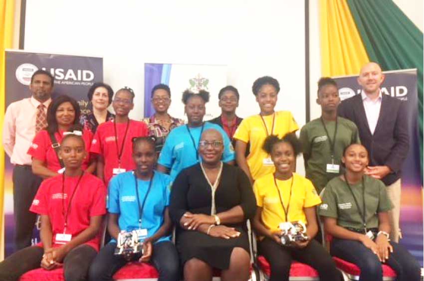 Image: Minister of Education Dr. Gale Rigobert (centre), Kipp Sutton, USAID General Development Office Director (right), along with other Community, Family and Youth Resilience (CFYR) Project officials and participating students.