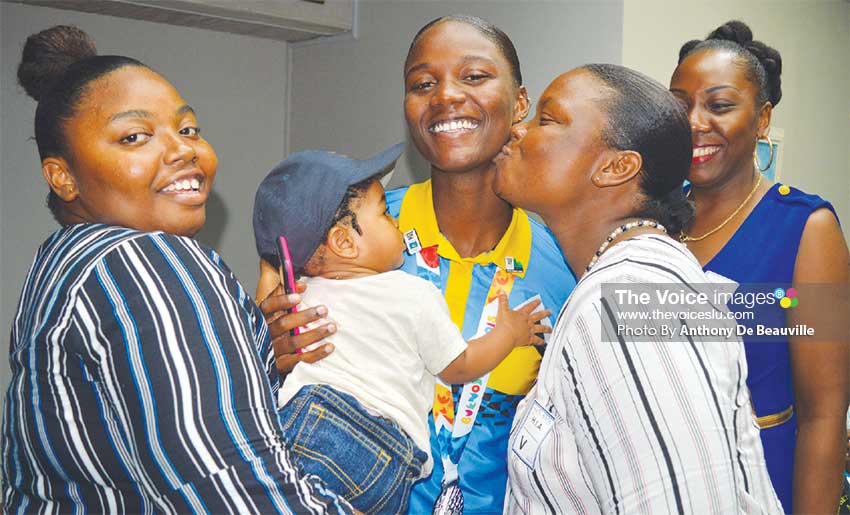 Image: Mother’s love, Big Kiss for Julien Alfred from Diana Alfred (Mother) while her sister and aunt looks on. (PHOTO: Anthony De Beauville)