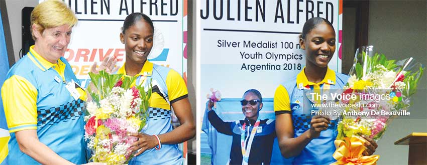 Image: (L-R) SLOC Treasurer - Joyce Huxley presenting Julien Alfred with a bouquet; Youth Olympian Julien Alfred second fastest 100 metre runner on the Planet. (PHOTO: Anthony De Beauville)