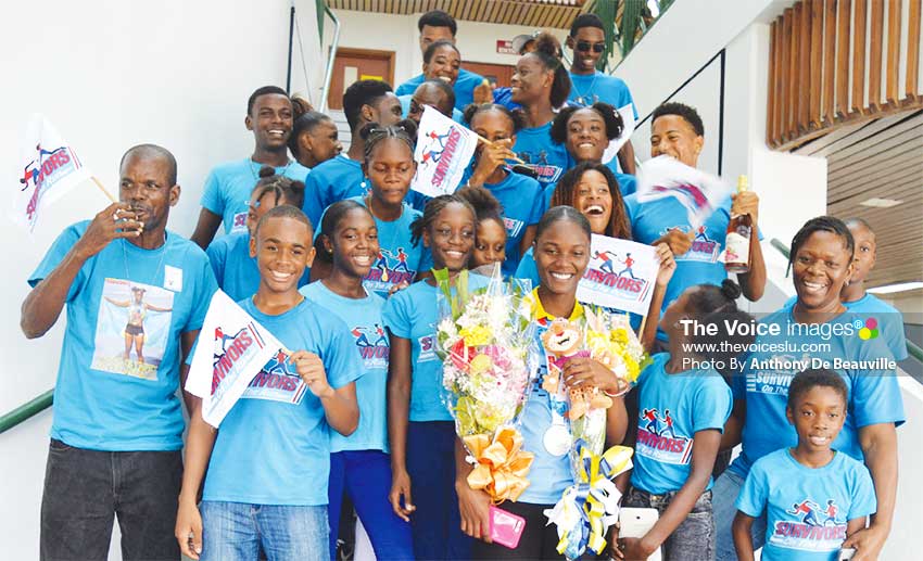 Image: Proud moment for Team Survivors track and field club, Head Coach - Cuthbert Modeste 1st from left and Youth Olympian - Julien Alfred. (PHOTO: Anthony De Beauville)