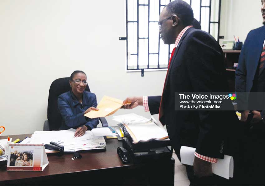 Image of Opposition Leader Philip J. Pierre submitting the draft motion to the Clerk of Parliament. (PHOTO: PhotoMike)