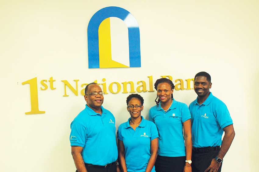 Image: (Left to right): Robert Fevrier, Mageesa Biscette, Sherydan Plummer and Michael Casimir. 1st National Bank’s Marketing Team at the website launch