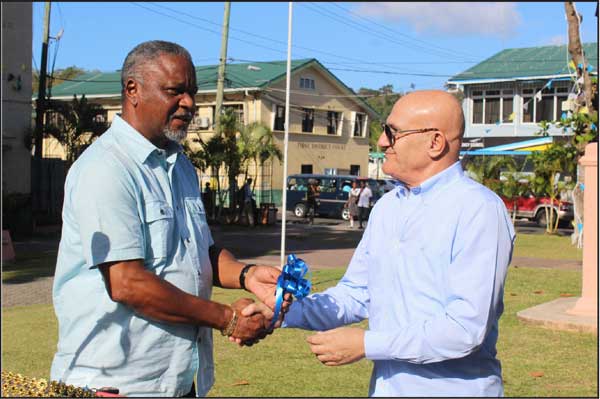 img:Maher Chreiki (right) handing over the keys to Minister of Home Affairs Hermangild Francis.