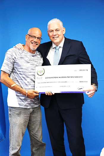 Image of Cornerstone's Mr. Desmond Phillip receiving donation of $250, 000 from Prime Minister Hon. Allen Chastanet