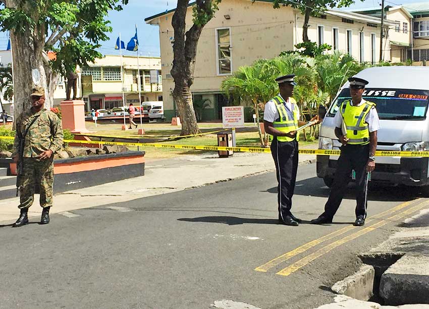 Image: Police officers stand guard near the First District Court where the bomb threat was made.