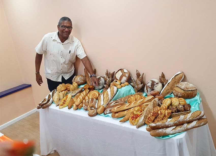 Image of Minister Felix showing off the Caribbean Grains 