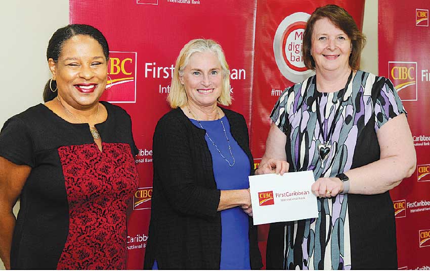 Image: Executive Director and co-founder of Hands Across the Sea, Mrs. Harriet Linskey, second from left receiving the donation cheque from Chief Executive Officer of CIBC FirstCaribbean International Bank and Chairperson of the ComTrust Foundation, Ms. Colette Delaney. Looking on is Mrs. Debra King, the bank’s Director of Corporate Communications and Director of ComTrust Foundation