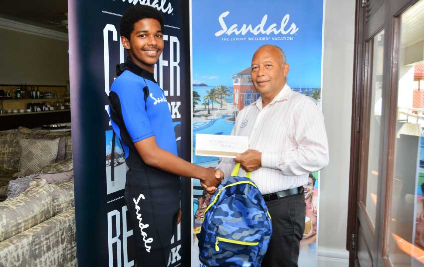 Image: Xaviour Blanchard receives his Sandals Foundation scholarship from the Managing Director of Sandals Resorts in Saint Lucia, Winston Anderson. 