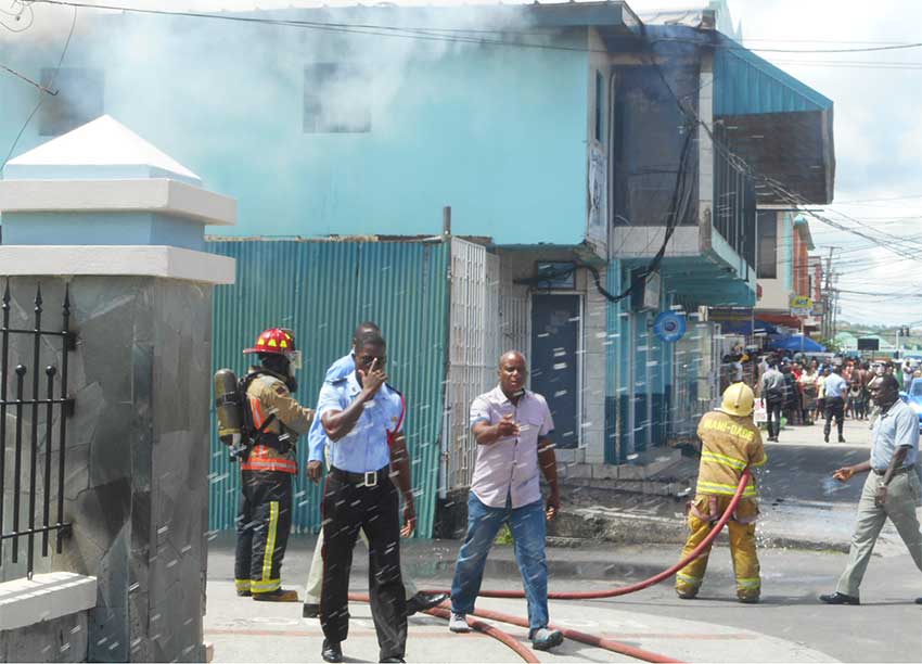 Firefighters finally able to get the Clarke Street fire under control. [PHOTO KINGSLEY EMMANUEL]