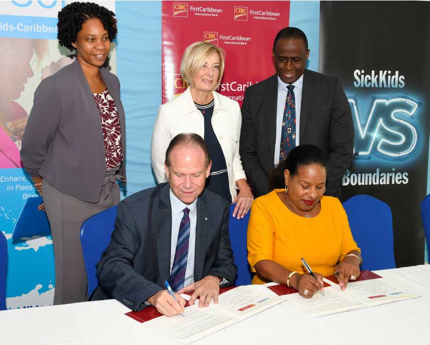 Image: CEO of SickKids Foundation Ted Garrard and Debra King, Director of Corporate Communications, CIBC FirstCaribbean sign the new MOU witnessed by SickKids Fellow Dr Chantelle Browne-Farmer (back left) Bonnie Fleming-Carol, Associate Chief of Nursing & Inter-professional Education at SickKids (centre) and Dr Upton Allen, Chief of the Division of Infectious Diseases at SickKids.