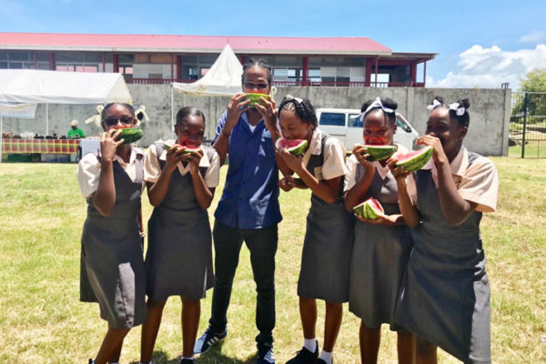 Image of students from the Micoud Secondary School participating in a Watermelon eating competition.