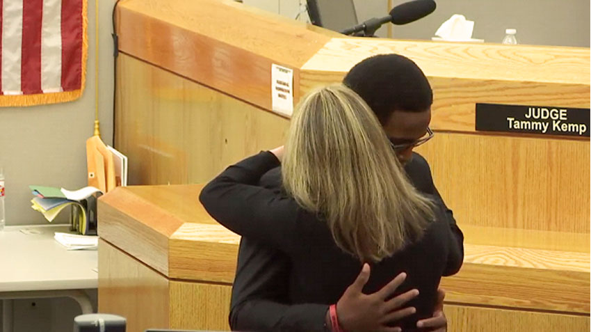 Image of Brandt Jean hugging a sobbing Amber Guyger minutes after she was handed down a 10 year sentence for the murder of his brother Botham Jean. 