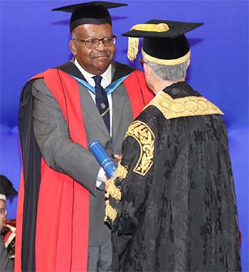 Image: Honourary Graduate His Excellency Sir Tapley Seaton, Governor-General of St Kitts and Nevis receiving his award from Chancellor Robert Bermudez.