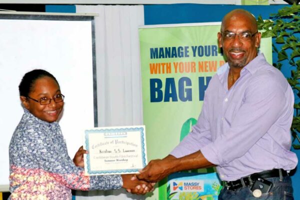 Image of Kristian Lawrence receiving her certificate of participation.