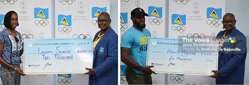 Image: (L-R) National athletes Levern Spencer and Albert Reynolds receiving their cheques from SLOC President, FortunaBelrose. (Photo: Anthony De Beauville) 