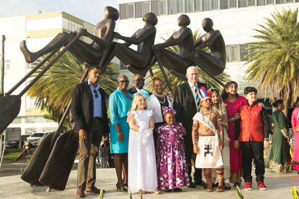 Image of Sculptor Jallim Eudovic with Government representatives and other participants in the unveiling of the "All In" Monument on the Castries Waterfront.