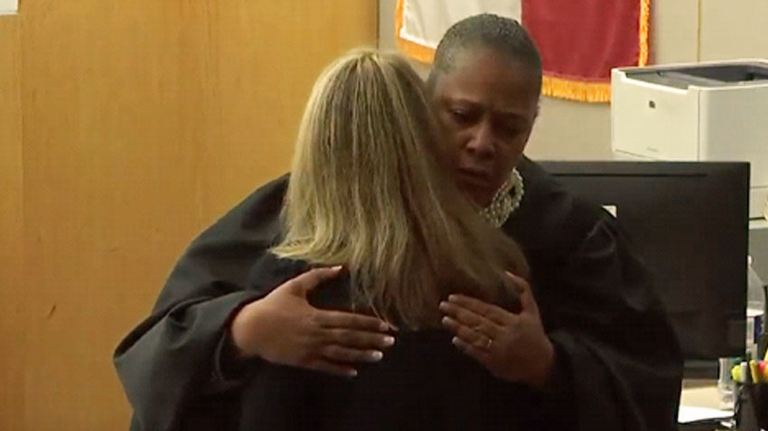 Image: Judge Tammy Kemp handed Amber Guyger a Bible and hugged her at the conclusion of the trial.
