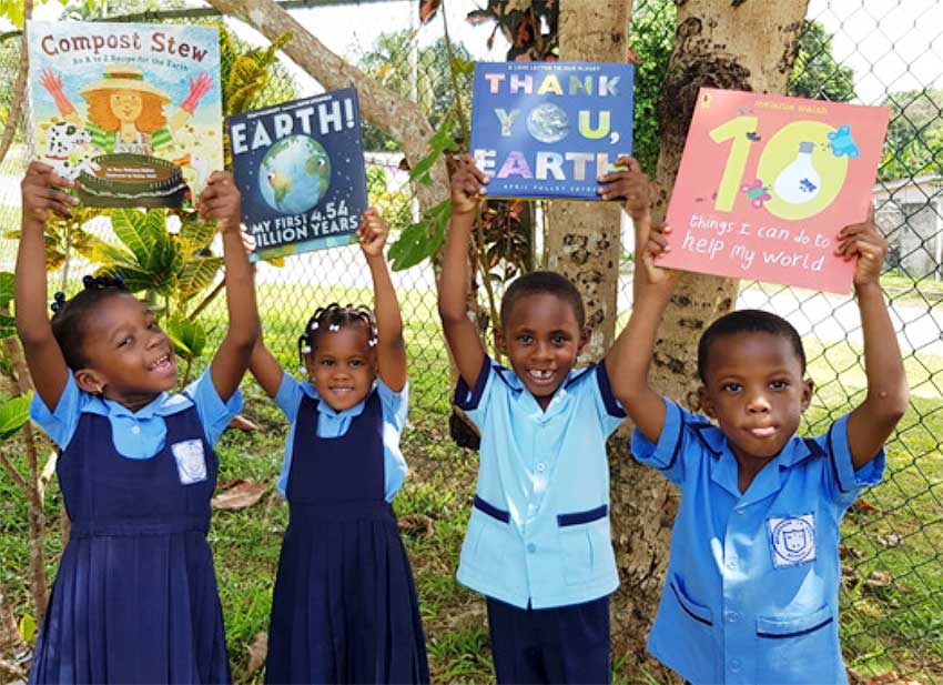 Image of Students at Moneague Teachers’ College Basic School in Jamaica, share bright smiles after taking part in a reading session with environmental books.