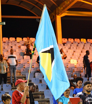 Image of a man at the game holding a Saint Lucian flag
