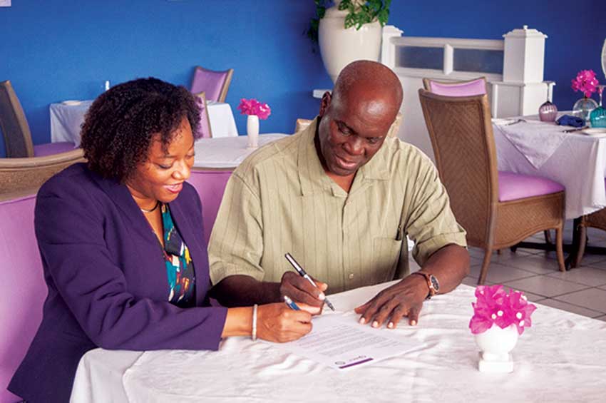 Image: Ms Carmel Haynes of RICS Americas and Mr. Tedburt Theobalds signing the MOU between the ISSLU and RICS.