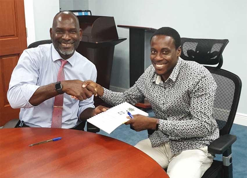 Image: Contractor Lwanga Willie signs his contract for drainage works in Desruisseaux with Mr. Claudius Emmanuel, Permanent Secretary of the Ministry of Economic Development, Housing, Urban Renewal, Transport and Civil Aviation under which the DVRP falls.