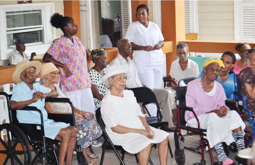 Image of residents with caregivers at the home.