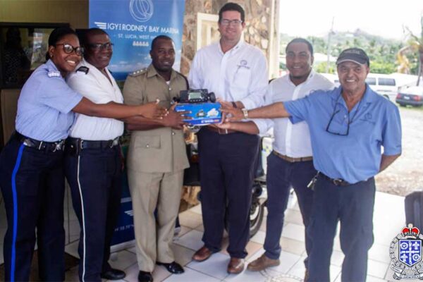 Image: IGY Rodney Bay Marina representatives presenting the new marine VHF radio to police officers from the Gros Islet Police Station.