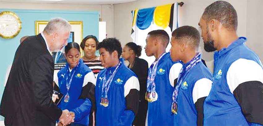 Image: Saint Lucia Prime Minister chitchart with swimmers on arrival at GLFCA VIP Lounge. (PHOTO: SM)
