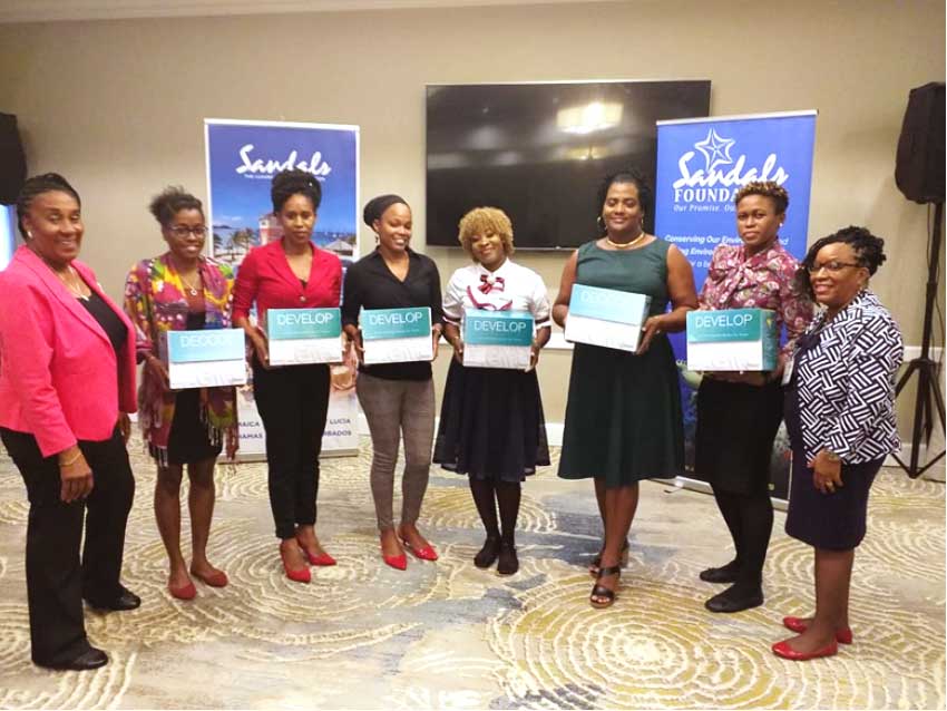 Image: Sheila Serville (extreme left), representatives of the six recipient institutions, and Clara Paul (at right).