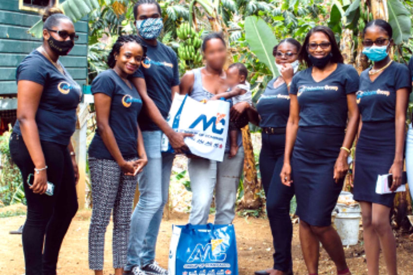 The M&C Volunteer Group and one of many individuals who received relief packages