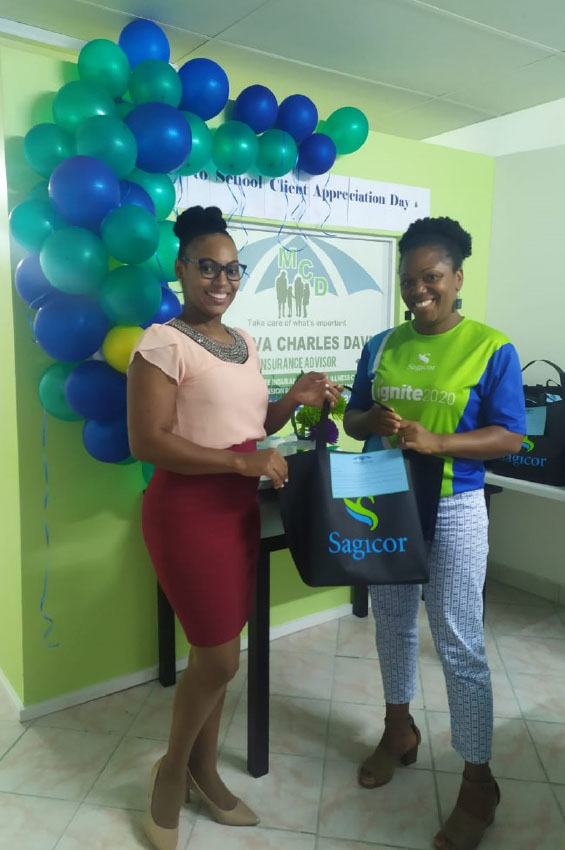 Image: Minerva Charles-David, Advisor with Sagicor presents a back to school package to Ms. Anetta Henry, a client.