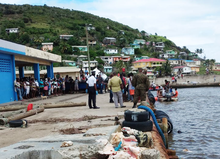 Image of curious onlookers converge on Dennery Fishing Port