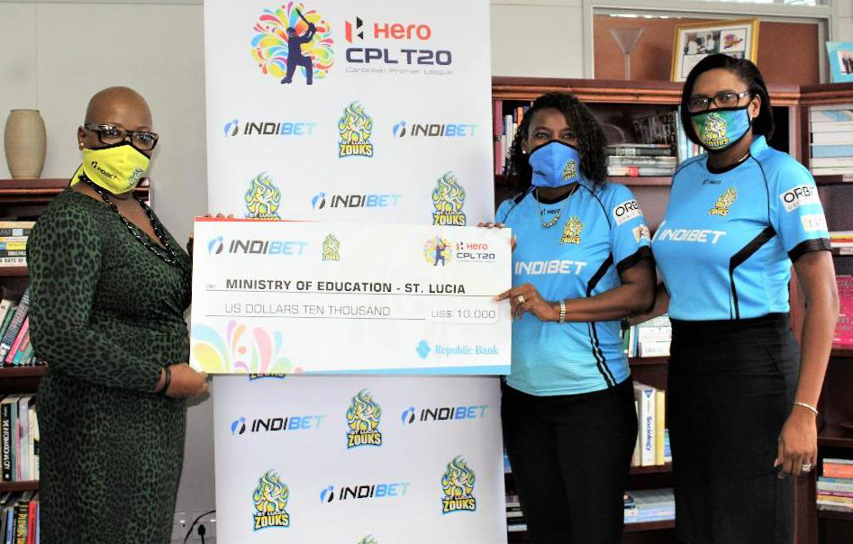 Image: (l-r) Minister for Education, Gale Rigobert receiving the US$10,000 dollars from Saint Lucia Zouks and Indibet representative, Sue Monplaisir (Photo: SM)