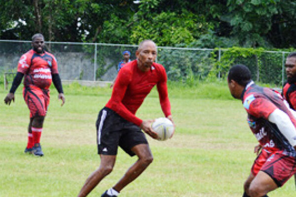 Image: Wayne Pantor with ball in hand showing some of yesteryear brilliance versus Whiptail Warriors; Wayne takes charge of the encounter as Referee. (PHOTO: Anthony De Beauville)