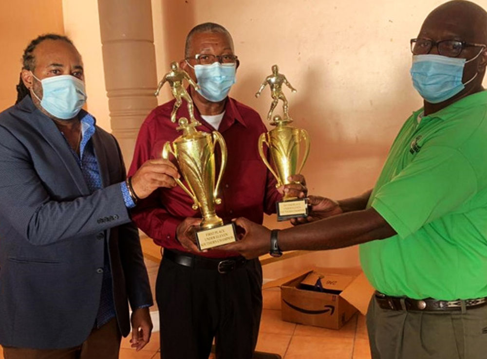 Image: Cletus Fevriere Mahy receiving the championship trophy from VFSFL representatives Trevor Clarke and Emmanuel Belase on behalf of Platinum FC (Photo: EB)