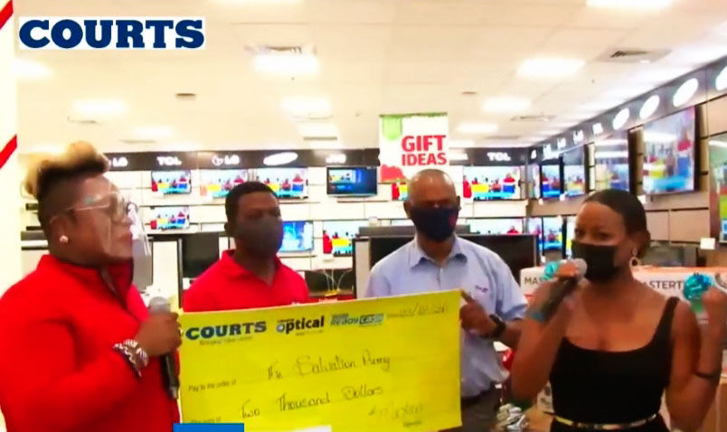 Image: Courts makes a donation to Major Derrick Mitchell of the St. Lucia Salvation Army.