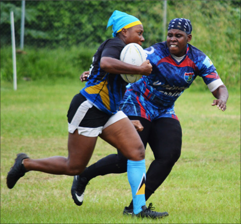 Image: Renetta Fredericks (Rogues) with ball in hand is challenged by Senetta Viger (Whiptail Warriors). (PHOTO: Anthony De Beauville)