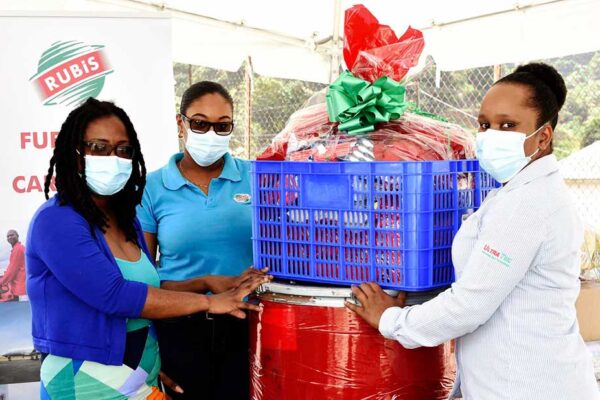 Image: (L-R) Alisha St Martin, Field Officer at the NCPD accepts a Christmas hamper from Chriselda Norbal and Vernesa Joseph of RUBIS.
