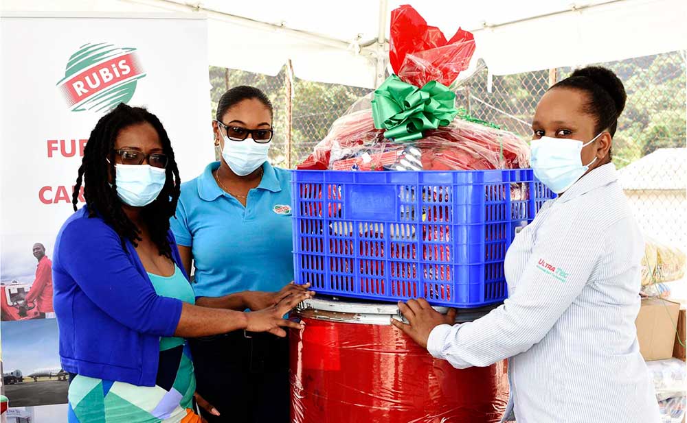 Image: (L-R) Alisha St Martin, Field Officer at the NCPD accepts a Christmas hamper from Chriselda Norbal and Vernesa Joseph of RUBIS.