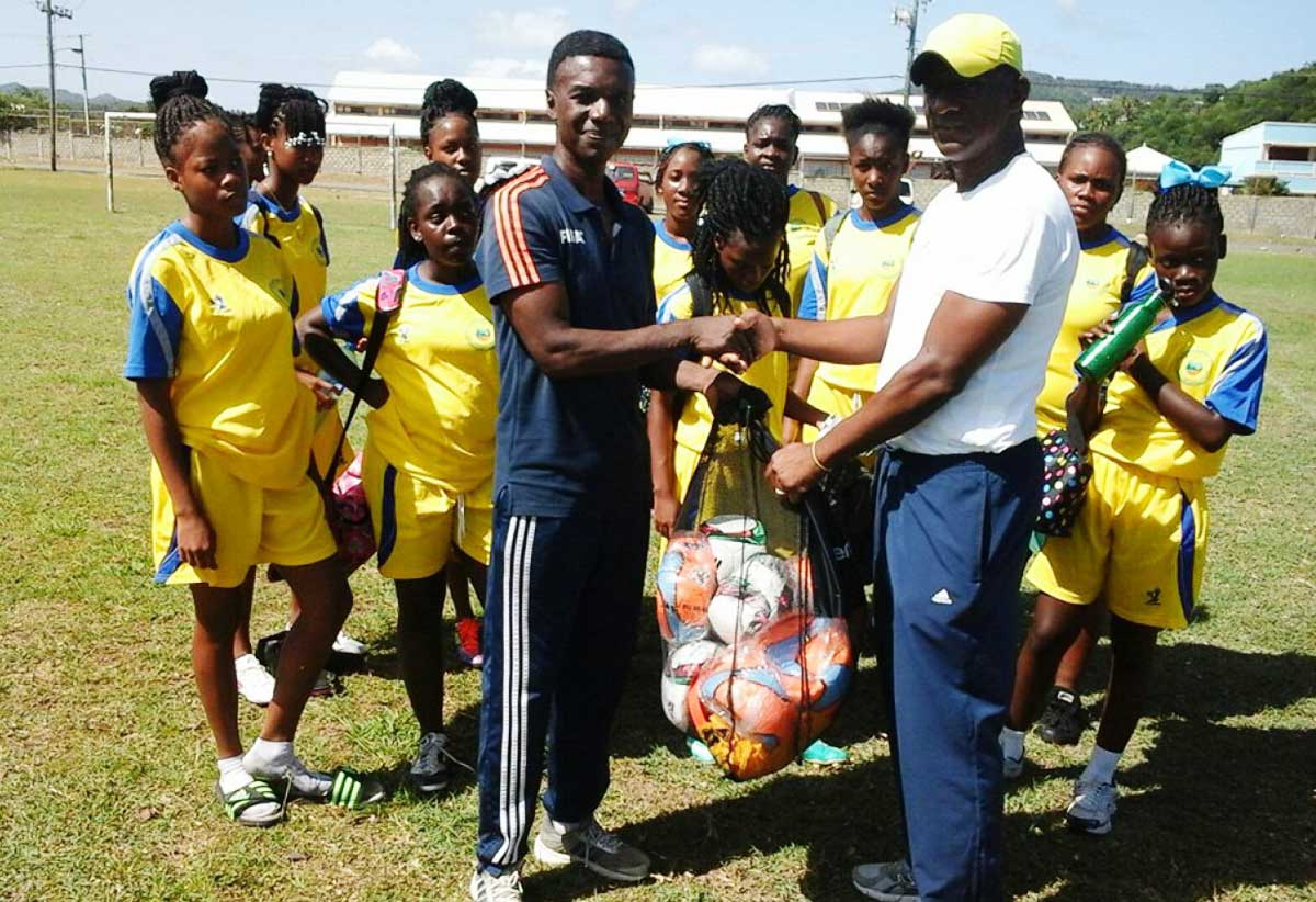 Image: SLFA Technical Director Ces Podd in training session with young female football players.