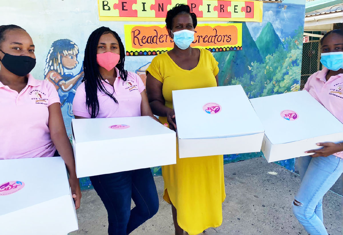 Image: Members of the group with the principal of the prinsipal of the Soufriere Primary School ready to distribute Fem-pacs.