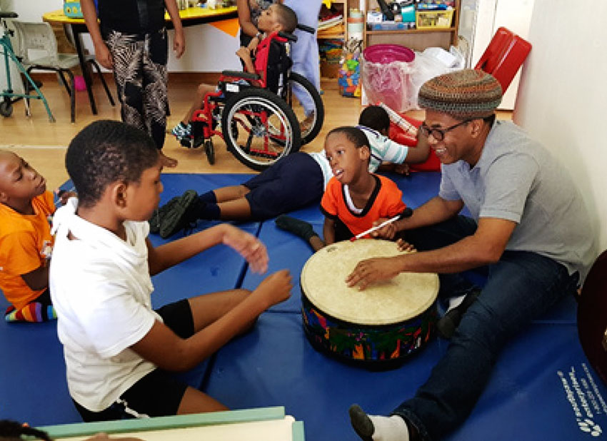 Music teacher John Polius and students.