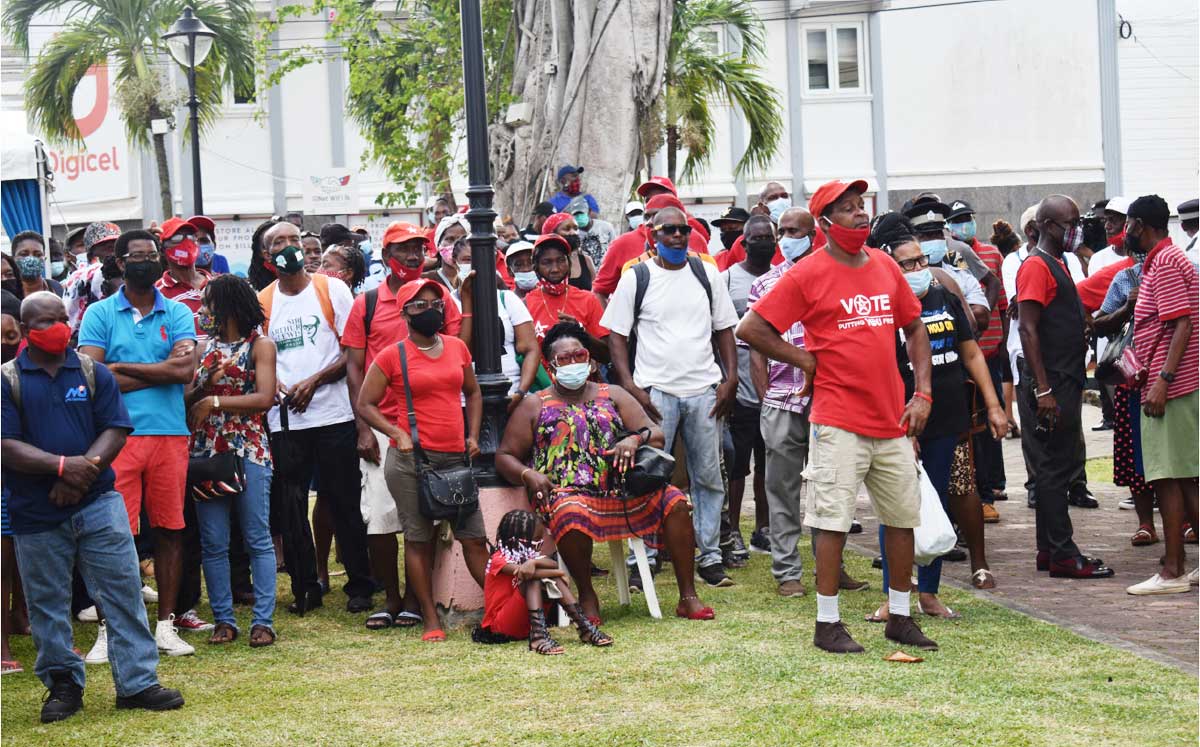 Crowd outside parliament building watching the swearing in of cabinet ministers Thursday.