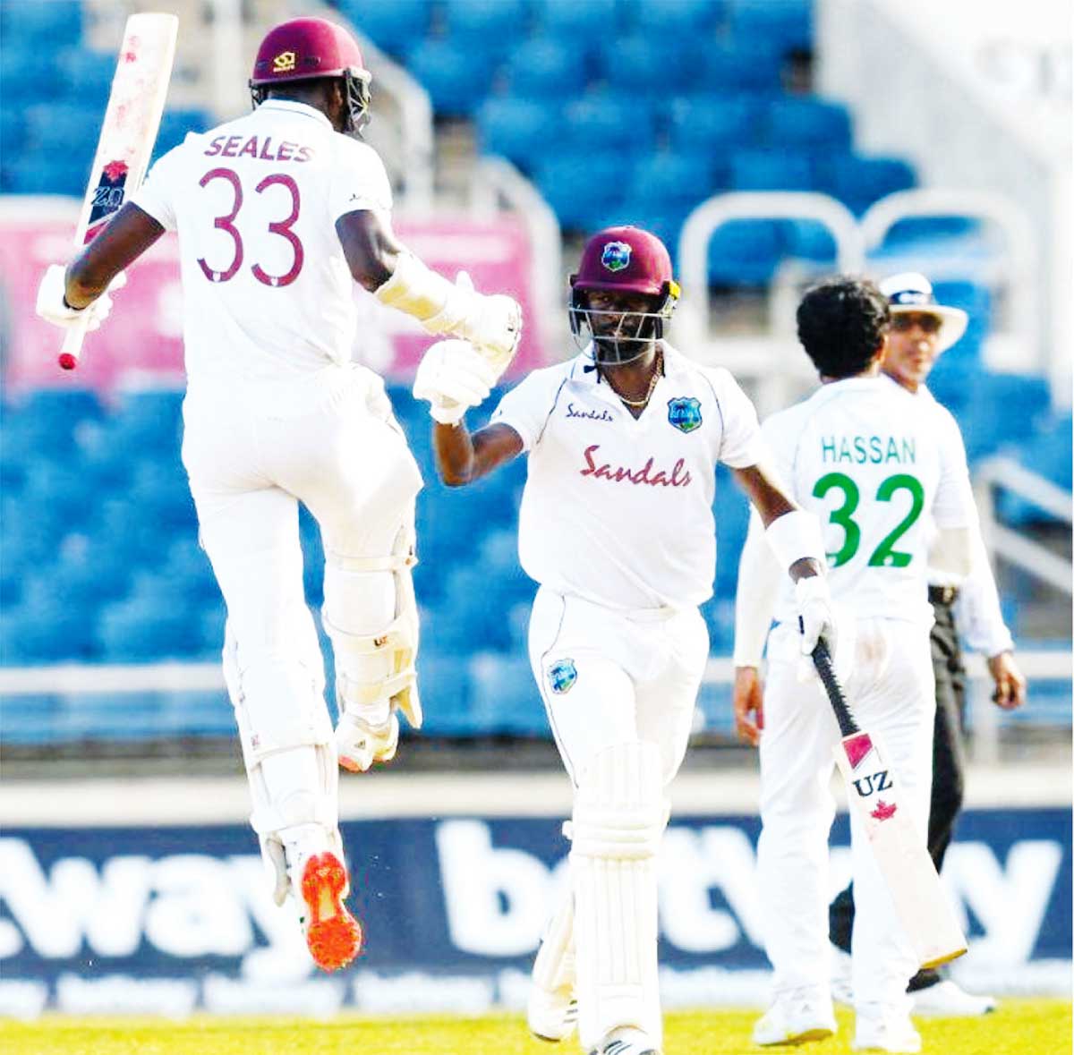 Jayden Seales and Kemar Roach bump fists after the winning runs. (Photo: AFP/GI)