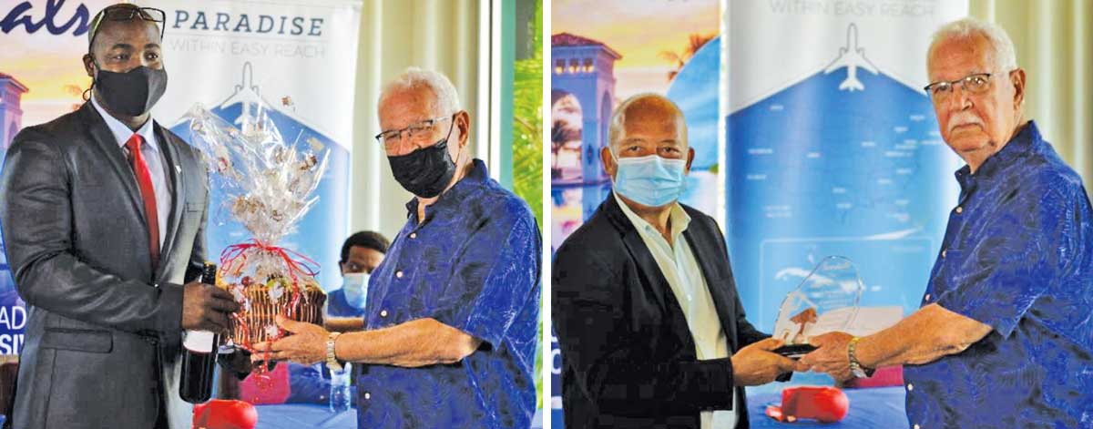 (L-R) Sports Minister, Kenson Casimir and Sandals Saint Lucia Managing Director, Winston Anderson presenting Perreira with a token of appreciation. (Photo: Anthony De Beauville)